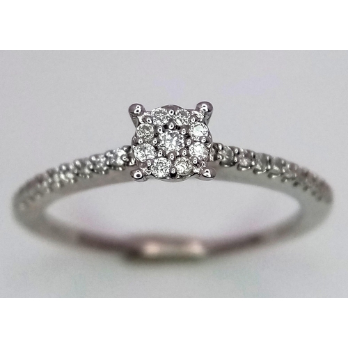 742 - A 9K White Gold Diamond Cluster Ring with Diamond Set Shoulders. Size L. 0.28ctw, 1.7g total weight.