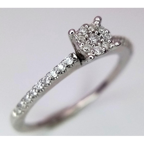 742 - A 9K White Gold Diamond Cluster Ring with Diamond Set Shoulders. Size L. 0.28ctw, 1.7g total weight.