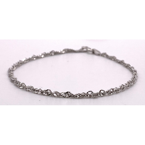 756 - A 9K White Gold Twist Bracelet. 19cm length, 0.9g total weight.