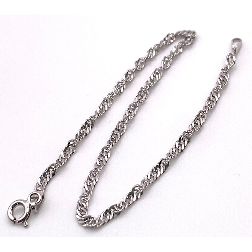 756 - A 9K White Gold Twist Bracelet. 19cm length, 0.9g total weight.