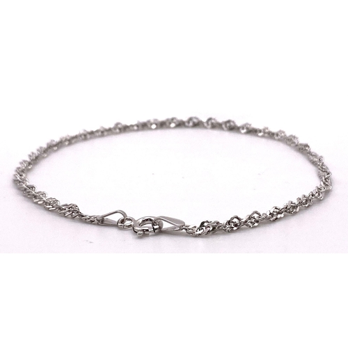 756 - A 9K White Gold Twist Bracelet. 19cm length, 0.9g total weight.