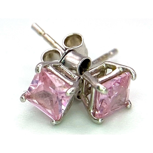 784 - A Pair of 9K White Gold, Princess Cut Pink Cubic Zirconia Stud Earrings. 0.7g total weight.