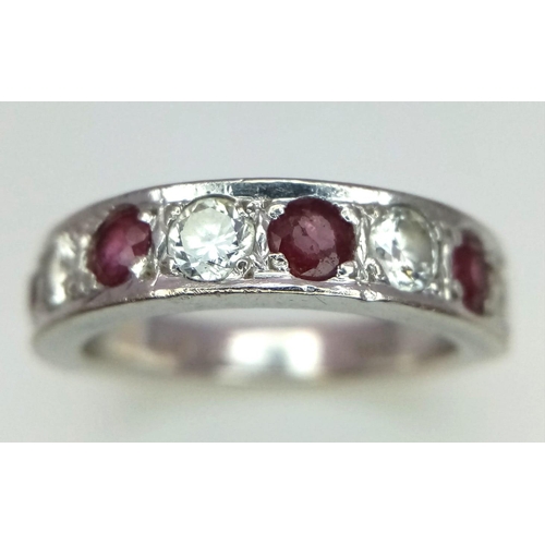 226 - An 18K White Gold Ruby and Diamond Half Eternity Ring. Nine gemstones. Size K. 5.89g total weight. R... 