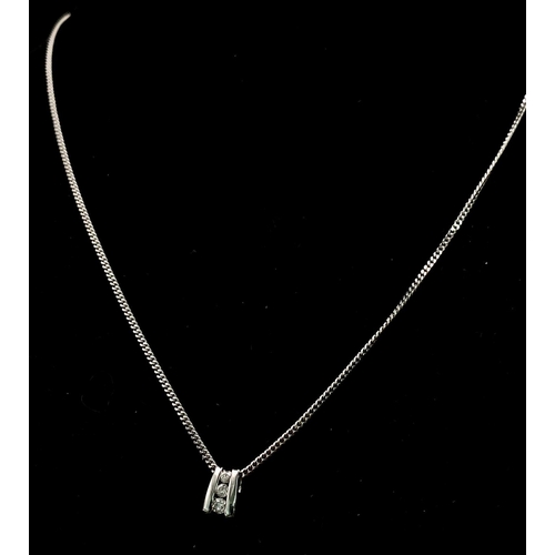 219 - An 18K White Gold and Three Diamond Pendant on a 9K White Gold Necklace. 0.10ctw - three diamonds. 3... 