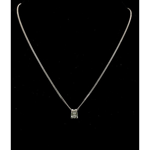 219 - An 18K White Gold and Three Diamond Pendant on a 9K White Gold Necklace. 0.10ctw - three diamonds. 3... 