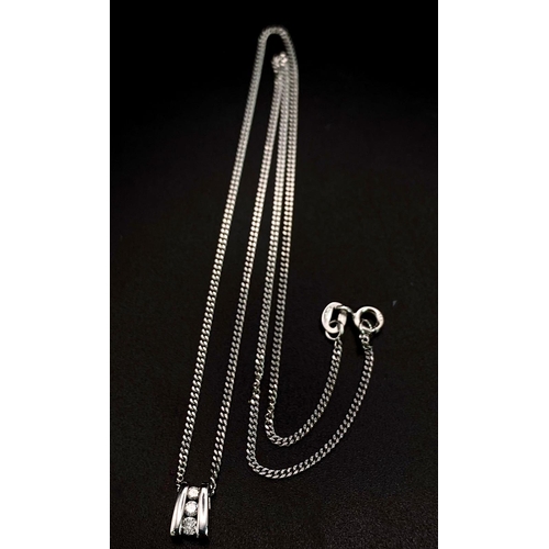 219 - An 18K White Gold and Three Diamond Pendant on a 9K White Gold Necklace. 0.10ctw - three diamonds. 3... 