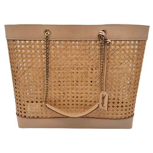 732 - A Saint Laurent Beige Tote Bag. Woven rattan and leather trim exterior. Magnetic closure, gold-toned... 