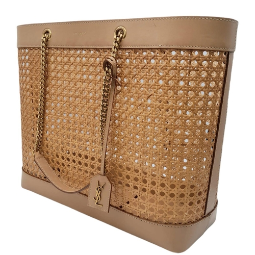 732 - A Saint Laurent Beige Tote Bag. Woven rattan and leather trim exterior. Magnetic closure, gold-toned... 