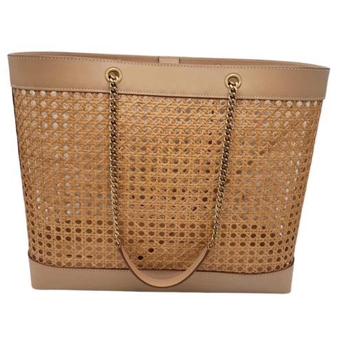 732 - A Saint Laurent Beige Tote Bag. Woven rattan and leather trim exterior. Magnetic closure, gold-toned... 