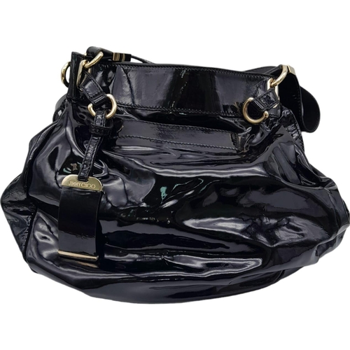 697 - Jimmy Choo Black Patent Leather Handbag.
Gorgeous feel to this handbag. Double strapped, with engrav... 