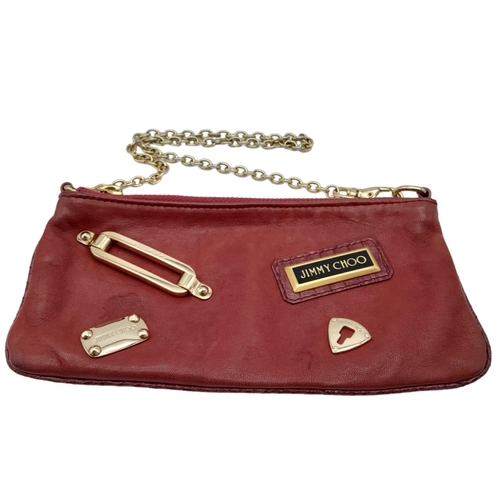 711 - A Jimmy Choo Magenta Bag. Leather exterior with gold-tone hardware and chain strap. Canvas interior,... 