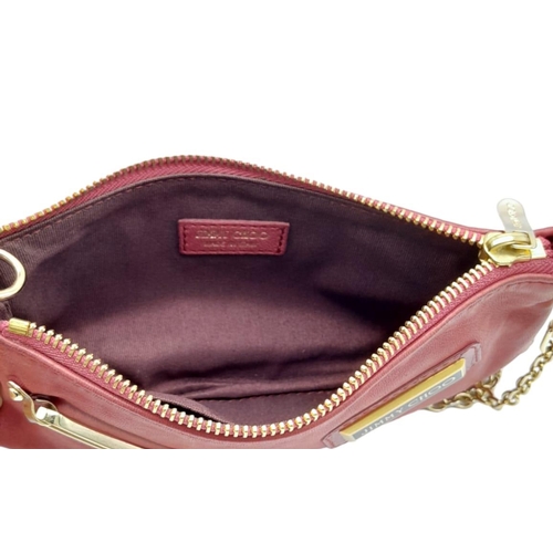 711 - A Jimmy Choo Magenta Bag. Leather exterior with gold-tone hardware and chain strap. Canvas interior,... 