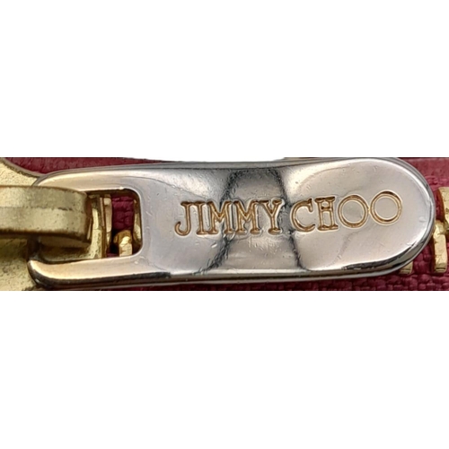 711 - A Jimmy Choo Magenta Bag. Leather exterior with gold-tone hardware and chain strap. Canvas interior,... 