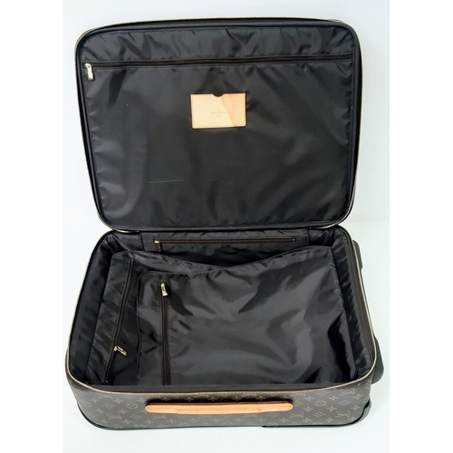 725 - A Louis Vuitton Monogram Pegase Suitcase. Durable leather exterior. Front compartment with zipper, c... 