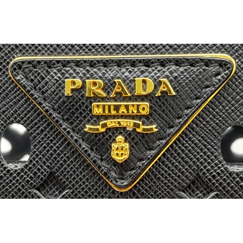 304 - A Prada Black Perforated Satchel Bag. Saffiano fori leather exterior, with an open top, two rolled h... 