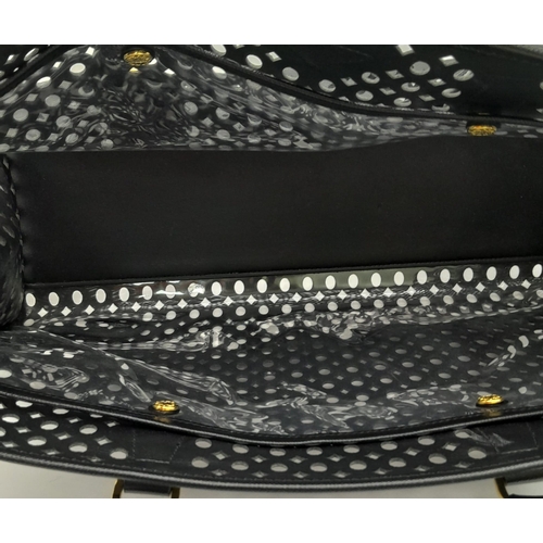 304 - A Prada Black Perforated Satchel Bag. Saffiano fori leather exterior, with an open top, two rolled h... 