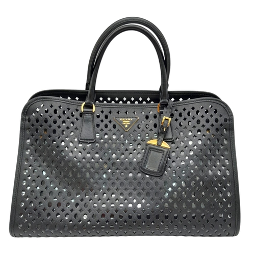 304 - A Prada Black Perforated Satchel Bag. Saffiano fori leather exterior, with an open top, two rolled h... 