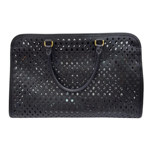 304 - A Prada Black Perforated Satchel Bag. Saffiano fori leather exterior, with an open top, two rolled h... 