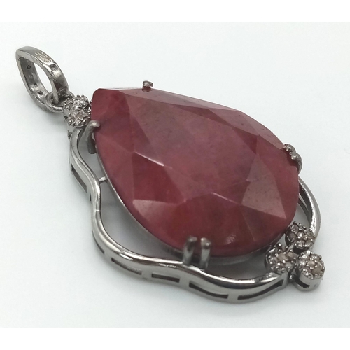 708 - A 55.95ct Ruby Teardrop Pendant with 0.45ctw of Diamond Accents. 17.5g total weight. 5.5cm. Comes wi... 