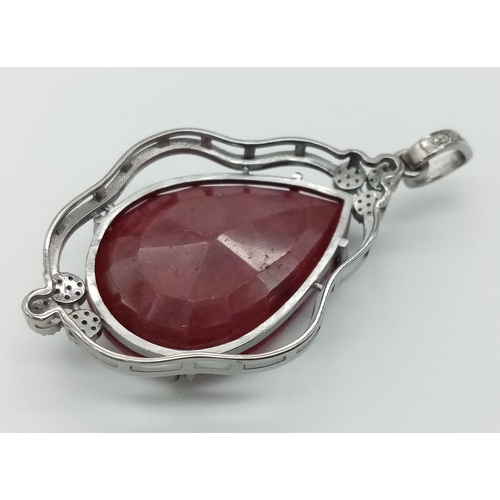 708 - A 55.95ct Ruby Teardrop Pendant with 0.45ctw of Diamond Accents. 17.5g total weight. 5.5cm. Comes wi... 