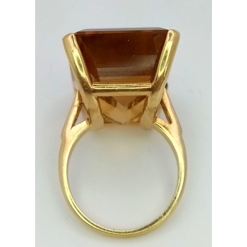 653 - An 18K Yellow Gold (tested) Citrine Ring. Immense 40ct approx, clean, rectangular cut citrine stone.... 