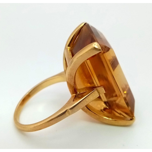 653 - An 18K Yellow Gold (tested) Citrine Ring. Immense 40ct approx, clean, rectangular cut citrine stone.... 