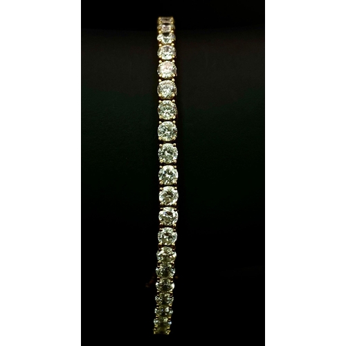 681 - A STUNNING 14K GOLD TENNIS BRACELET WITH BRIGHT SPARKLING ZIRCONIA STONES.   9.8gms