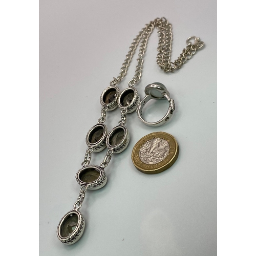 682 - Pairing of Sterling Silver Necklace and Ring.
Necklace features six smoky brown gemstones whilst the... 