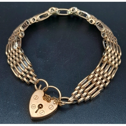 934 - A vintage (but in vogue again!!!) 9 K yellow gold articulate bracelet with a heart shaped padlock cl... 