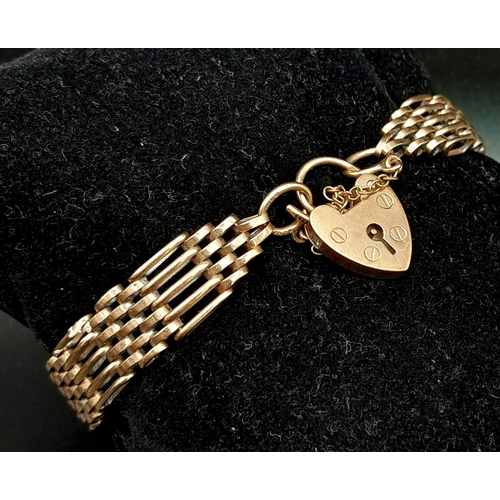 934 - A vintage (but in vogue again!!!) 9 K yellow gold articulate bracelet with a heart shaped padlock cl... 