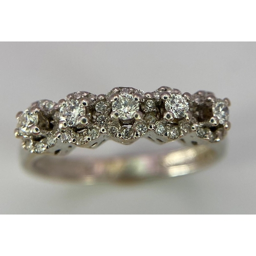 956 - A Vintage 18K White Gold Five Stone Diamond Ring. Five brilliant round cut diamonds each with its ow... 