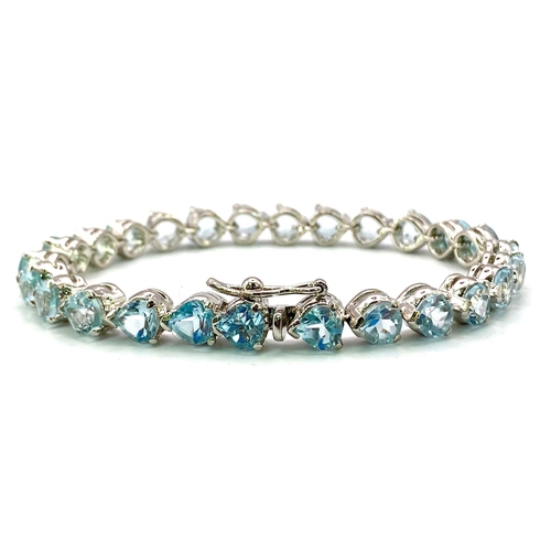 324 - A Blue Topaz Teardrop Tennis Bracelet. 26 Blue Topaz Gemstones. Set in 925 Sterling silver. 26.70g t... 