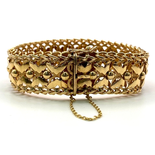 4 - A 9K GOLD INTERLINK BRACELET ORNATE X-FACTOR DESIGN ALSO HAVING A SAFETY CATCH AND SAFETY CHAIN .   ... 