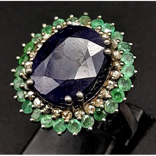 416 - A 9.80ct Oval Blue Sapphire Ring with 3.10ctw Emerald Halo and 0.50ct Diamond inner Halo. Set in 925... 