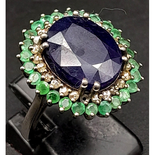 416 - A 9.80ct Oval Blue Sapphire Ring with 3.10ctw Emerald Halo and 0.50ct Diamond inner Halo. Set in 925... 