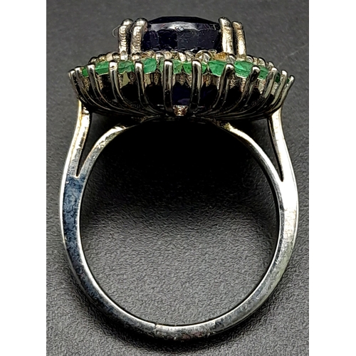 416 - A 9.80ct Oval Blue Sapphire Ring with 3.10ctw Emerald Halo and 0.50ct Diamond inner Halo. Set in 925... 