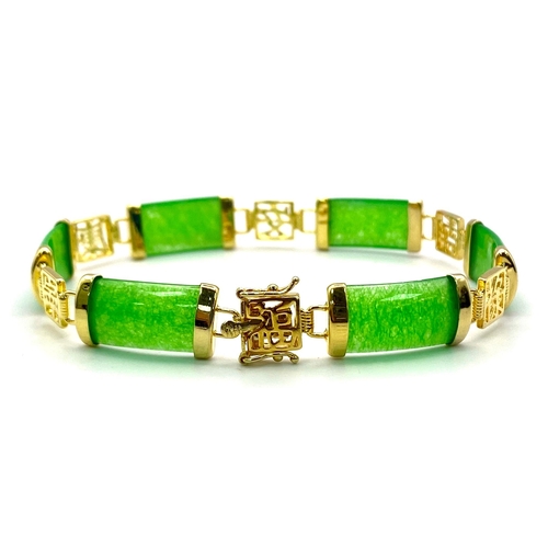 424 - A Thin Green Jade Bar Bracelet on Gold Plated Metal. Chinese symbol spacers. 19cm.