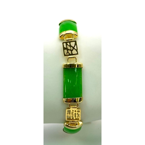 424 - A Thin Green Jade Bar Bracelet on Gold Plated Metal. Chinese symbol spacers. 19cm.