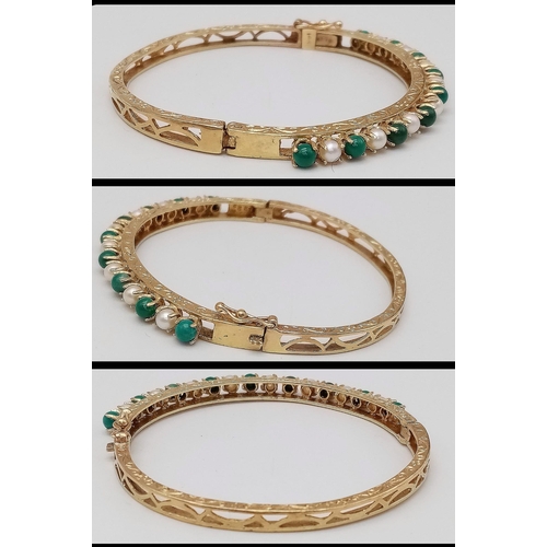 492 - A 14K GOLD HINGED BANGLE DECORATED WITH JADE AND SEED PEARLS WITH OPEN WORK BACK HALF AND NICELY HAN... 