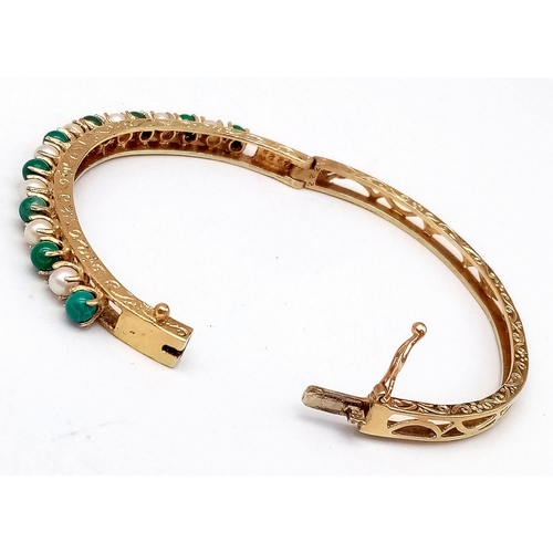 492 - A 14K GOLD HINGED BANGLE DECORATED WITH JADE AND SEED PEARLS WITH OPEN WORK BACK HALF AND NICELY HAN... 