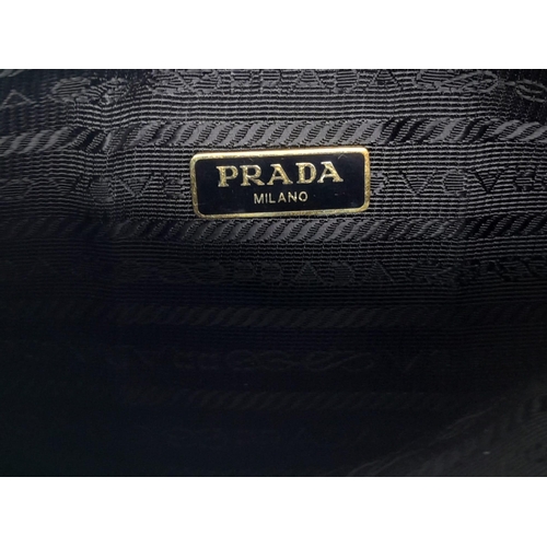 53 - A Prada Black Re-Edition 2005 Mini Bag. Saffiano leather exterior with gold tone hardware, and the i... 