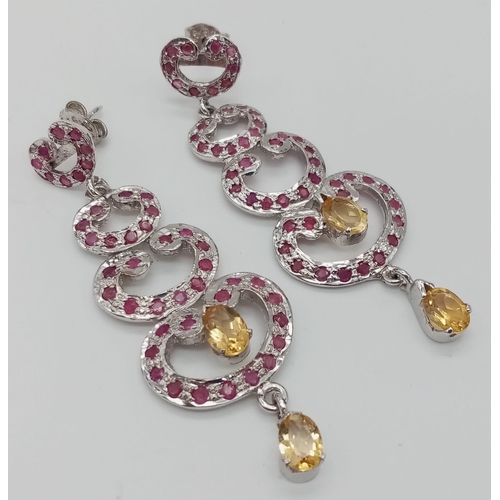 547 - A Pair of Graduating Ruby and Citrine 'Love-Heart' Drop Earrings set in 925 Sterling silver. Rubies ... 