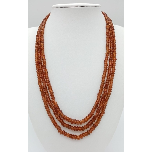 555 - A Three Row Hessonite Garnet Small Rondelle Bead Necklace. 245ctw. 925 Silver Clasp. 40-46cm length.