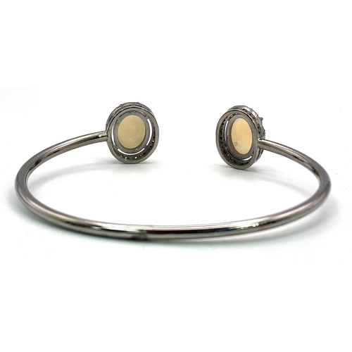 631 - An Opal Cuff Bangle with Rose-Cut Diamond Halos. Set in 925 Sterling silver. Ethiopian Opal Cabochon... 