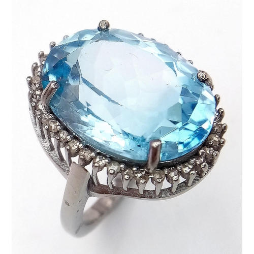 65 - An Ice Blue Topaz and 925 Silver Ring with a Rose-Cut Diamond Halo.  Blue topaz-16.50ct. Diamonds-0.... 