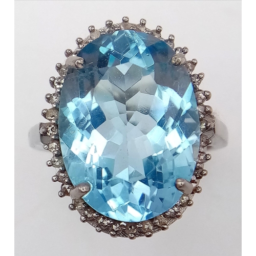 65 - An Ice Blue Topaz and 925 Silver Ring with a Rose-Cut Diamond Halo.  Blue topaz-16.50ct. Diamonds-0.... 