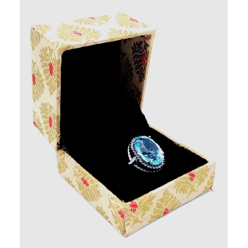 65 - An Ice Blue Topaz and 925 Silver Ring with a Rose-Cut Diamond Halo.  Blue topaz-16.50ct. Diamonds-0.... 