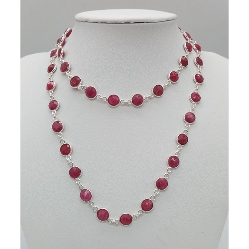 696 - A Round Cut Ruby Gemstone Tennis Necklace set in 925 Silver. 70cm. 27.75g total weight.