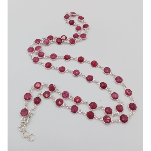 696 - A Round Cut Ruby Gemstone Tennis Necklace set in 925 Silver. 70cm. 27.75g total weight.