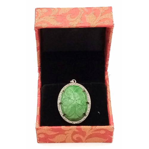 716 - A Hand-Carved Decorative Emerald Pendant with Rose-Cut Diamond Halo. Set in 925 Sterling silver. Eme... 